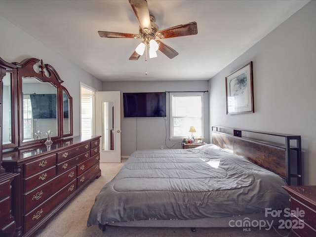 bedroom featuring ceiling fan and light colored carpet