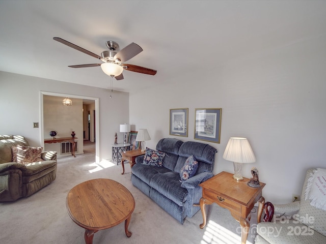 living room featuring light carpet and ceiling fan