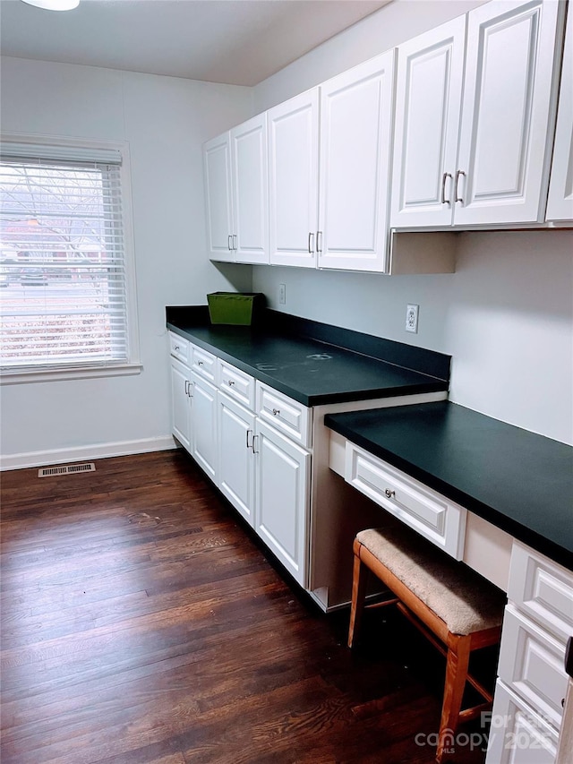 kitchen featuring white cabinets and dark hardwood / wood-style floors