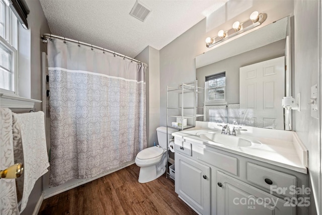 bathroom featuring hardwood / wood-style floors, vanity, a textured ceiling, and toilet