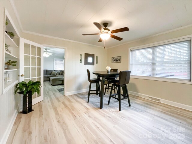 dining area with light hardwood / wood-style flooring, ceiling fan, and crown molding