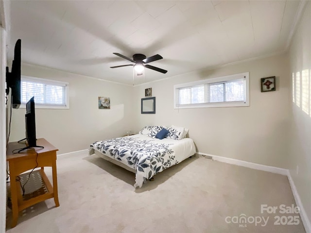 bedroom featuring carpet floors, ceiling fan, and crown molding