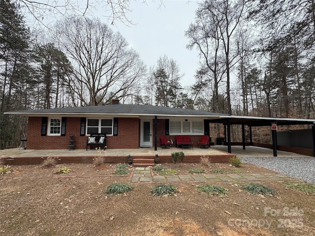 ranch-style home featuring a carport