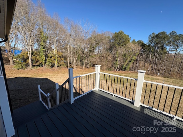 wooden terrace featuring a lawn