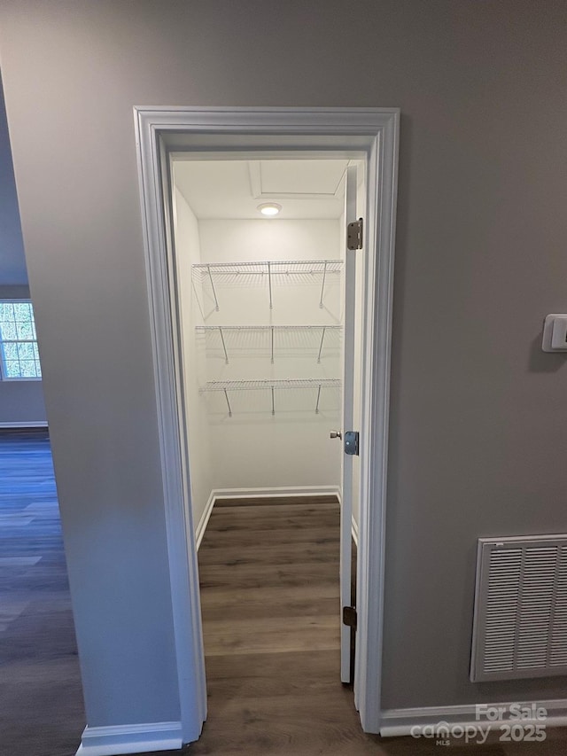 spacious closet with dark hardwood / wood-style floors