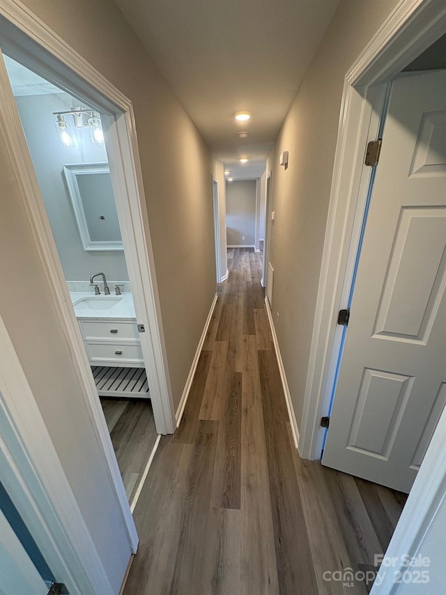 hallway featuring dark hardwood / wood-style floors and sink