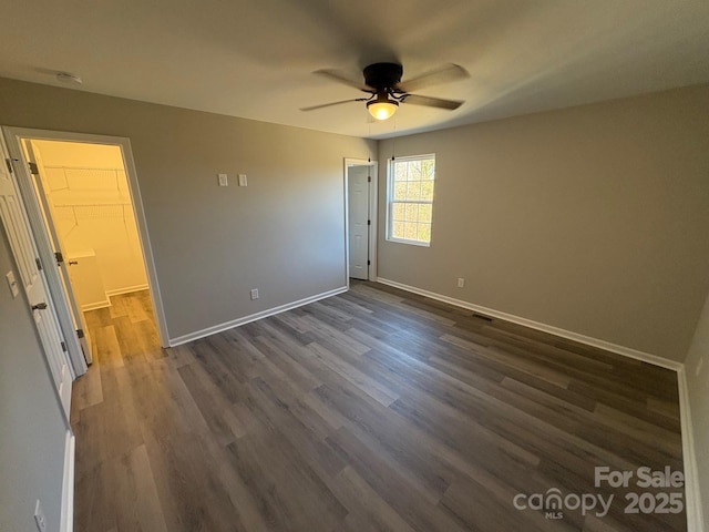 unfurnished bedroom featuring dark hardwood / wood-style flooring, a closet, and ceiling fan