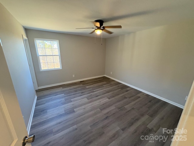 unfurnished room with ceiling fan and dark hardwood / wood-style flooring