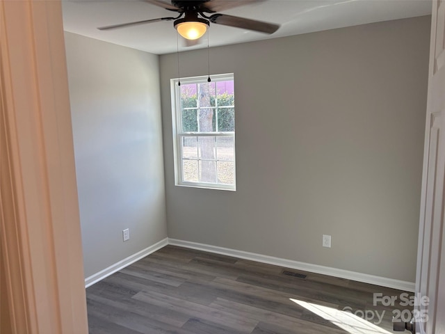 unfurnished room featuring ceiling fan and dark hardwood / wood-style flooring