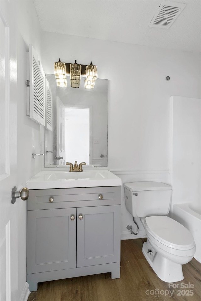 bathroom featuring hardwood / wood-style floors, toilet, and vanity