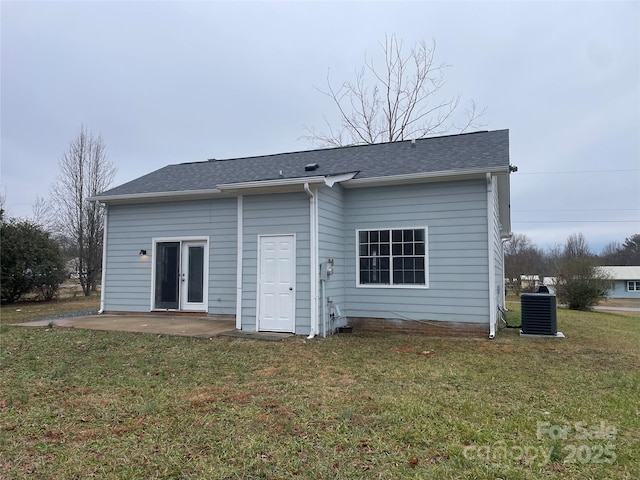 rear view of house with central AC, a yard, and a patio