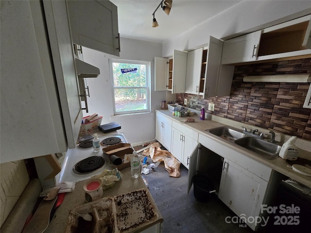 kitchen with gray cabinets, decorative backsplash, sink, and extractor fan