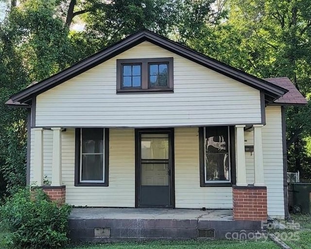 back of house featuring a porch