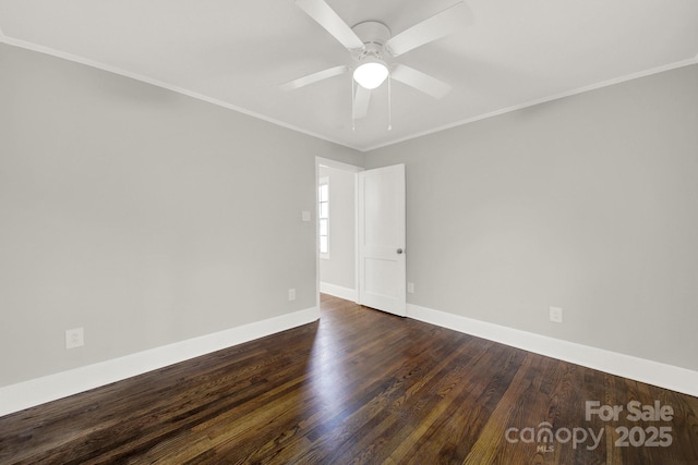 spare room featuring dark hardwood / wood-style flooring, ceiling fan, and crown molding