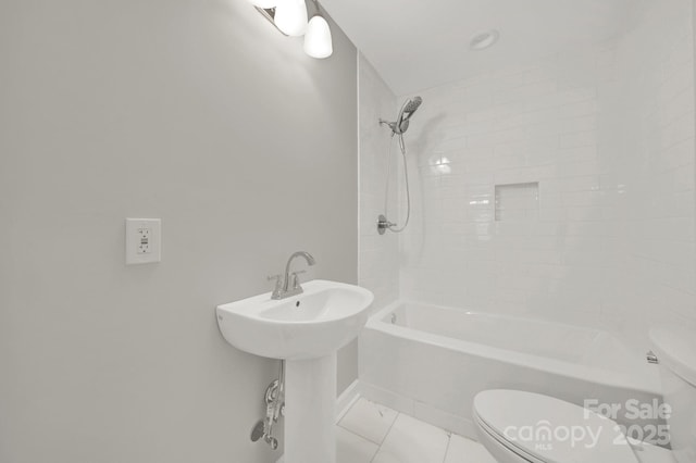 full bathroom featuring sink, tile patterned flooring, tiled shower / bath, and toilet