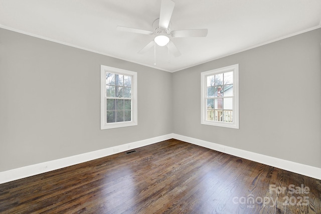 empty room featuring crown molding, ceiling fan, a healthy amount of sunlight, and dark hardwood / wood-style floors