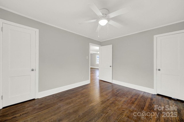 spare room with crown molding, ceiling fan, and dark wood-type flooring