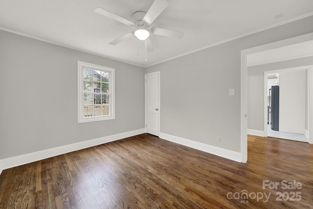 spare room with ceiling fan, dark hardwood / wood-style flooring, and ornamental molding