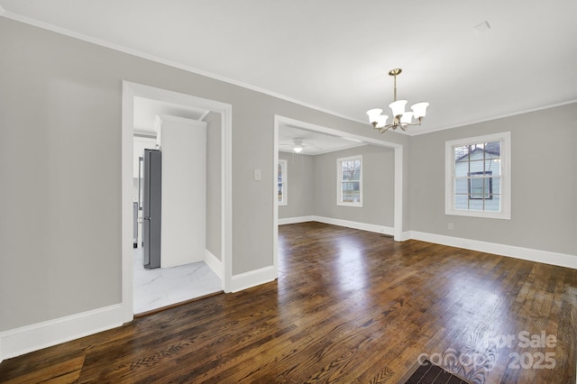 unfurnished room with ceiling fan with notable chandelier, dark hardwood / wood-style flooring, and crown molding