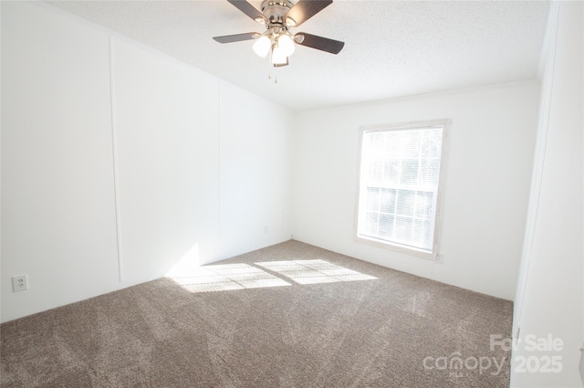 unfurnished room with light carpet, ceiling fan, and a textured ceiling