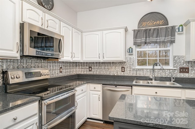 kitchen with white cabinets, sink, and appliances with stainless steel finishes