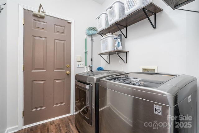 laundry area featuring dark hardwood / wood-style flooring and washer and clothes dryer