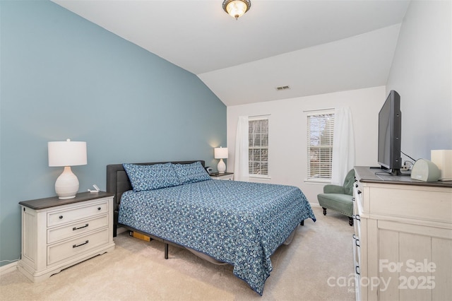 carpeted bedroom with vaulted ceiling