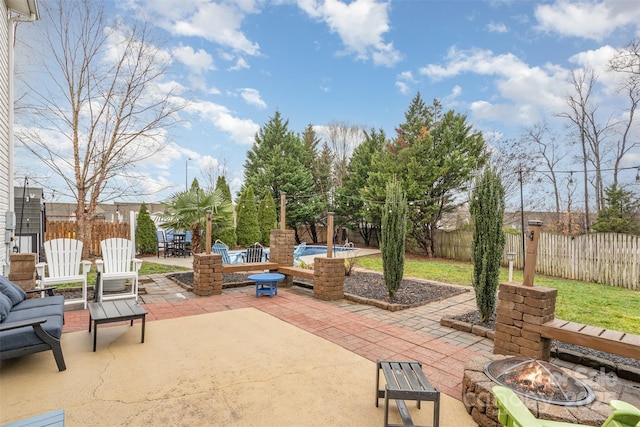 view of patio with a fire pit and a swimming pool