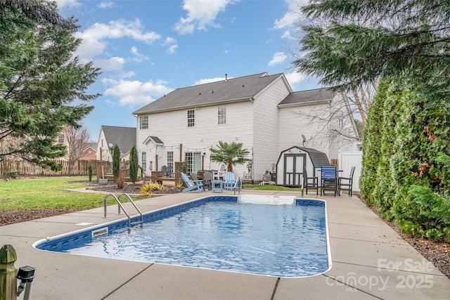 view of pool with a storage unit, a yard, and a patio