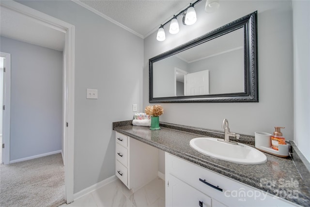 bathroom with vanity, a textured ceiling, and ornamental molding