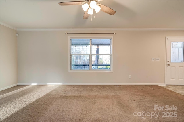 carpeted spare room featuring ceiling fan and crown molding