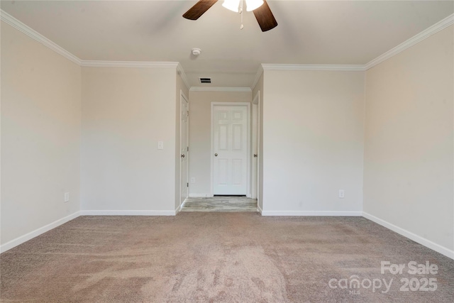 carpeted spare room featuring ceiling fan and ornamental molding