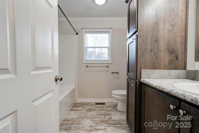 full bathroom with vanity, bathing tub / shower combination, toilet, and crown molding