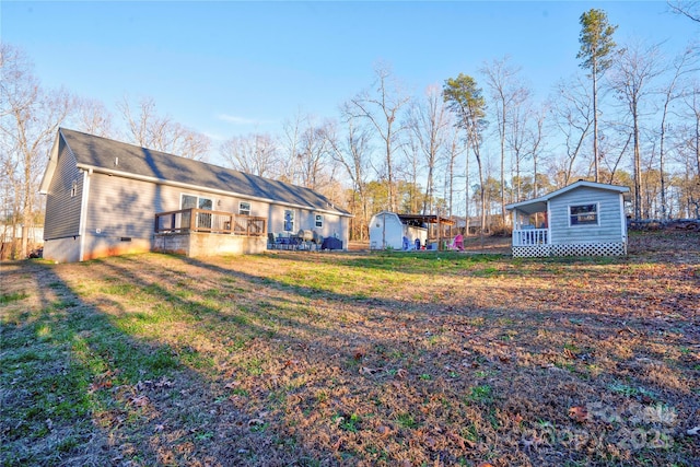 view of yard featuring a shed and a deck