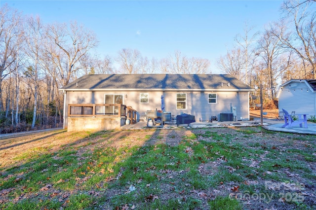 rear view of house with central AC, a patio, a deck, and a lawn