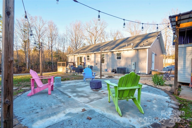 view of patio / terrace with central AC and an outdoor fire pit