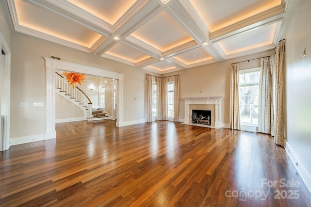 unfurnished living room with beamed ceiling, a fireplace, and coffered ceiling