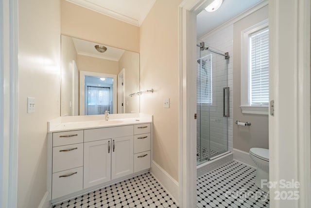 bathroom featuring ornamental molding, vanity, a shower with door, tile patterned flooring, and toilet