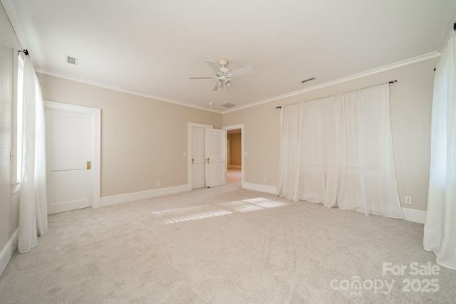 spare room with light carpet, ceiling fan, and ornamental molding