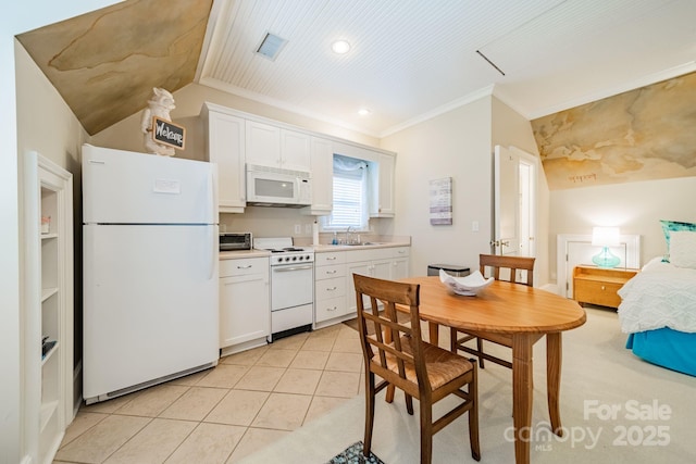 kitchen featuring sink, light tile patterned floors, crown molding, white appliances, and white cabinets