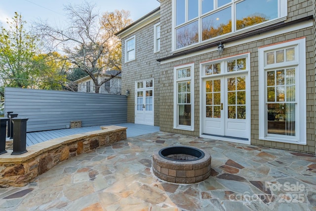 view of patio / terrace featuring french doors and a fire pit