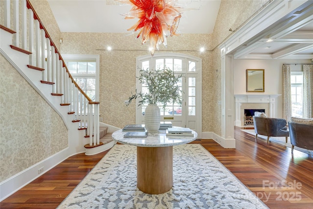 1333 Carlton Ave, Charlotte, NC 28203 - entrance foyer with a fireplace with flush hearth, wallpapered walls, stairway, and dark wood-style flooring