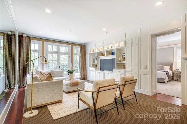 1333 Carlton Ave, Charlotte, NC 28203 - living room featuring crown molding, wood finished floors, recessed lighting, and a decorative wall
