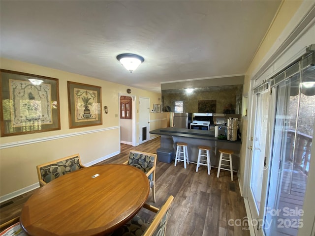 dining space featuring dark wood-type flooring