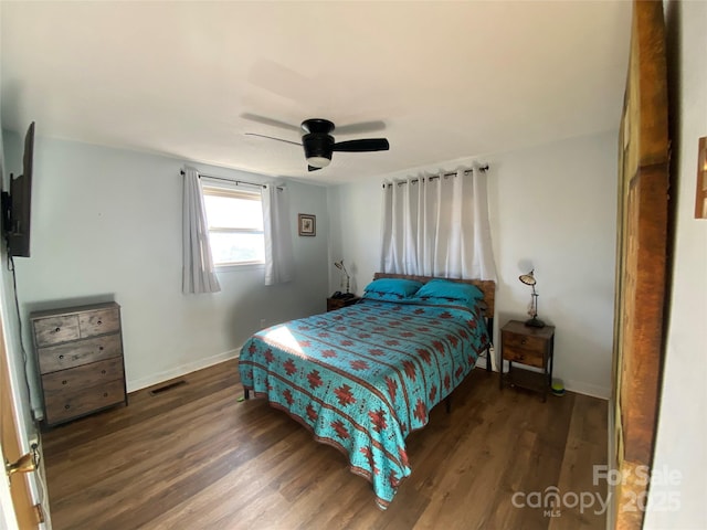 bedroom featuring ceiling fan and dark hardwood / wood-style floors