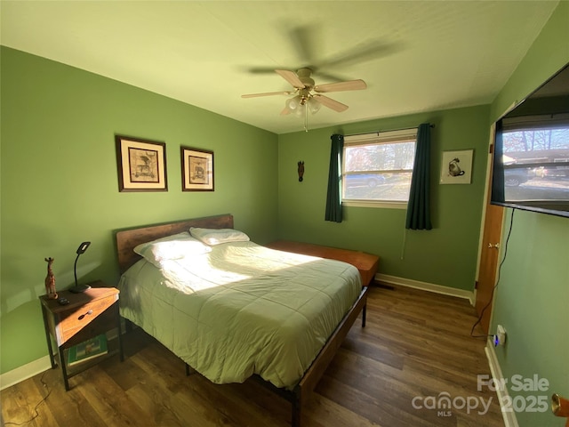 bedroom with multiple windows, ceiling fan, and dark wood-type flooring