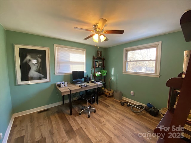 office featuring light hardwood / wood-style floors and ceiling fan