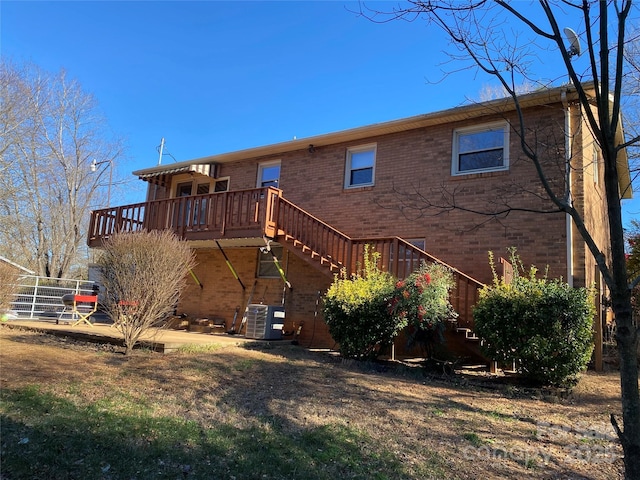 rear view of property with central AC unit and a deck