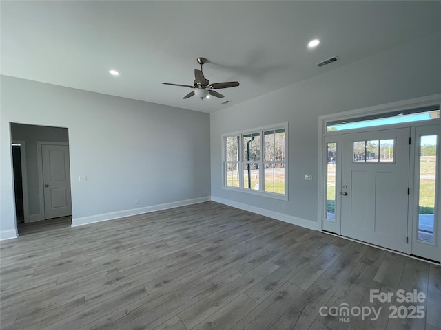 foyer with plenty of natural light, light hardwood / wood-style floors, and ceiling fan