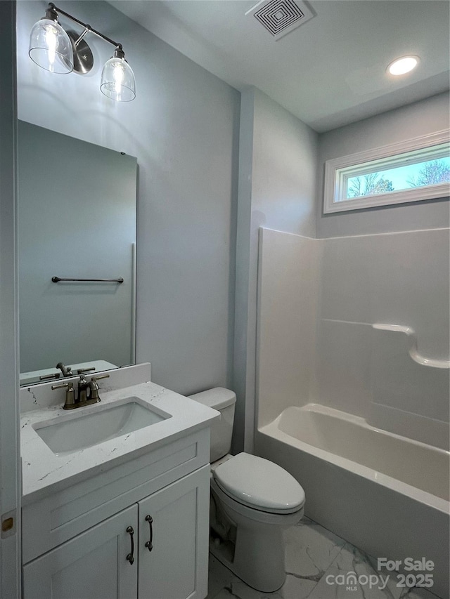 full bathroom with shower / tub combination, vanity, and toilet